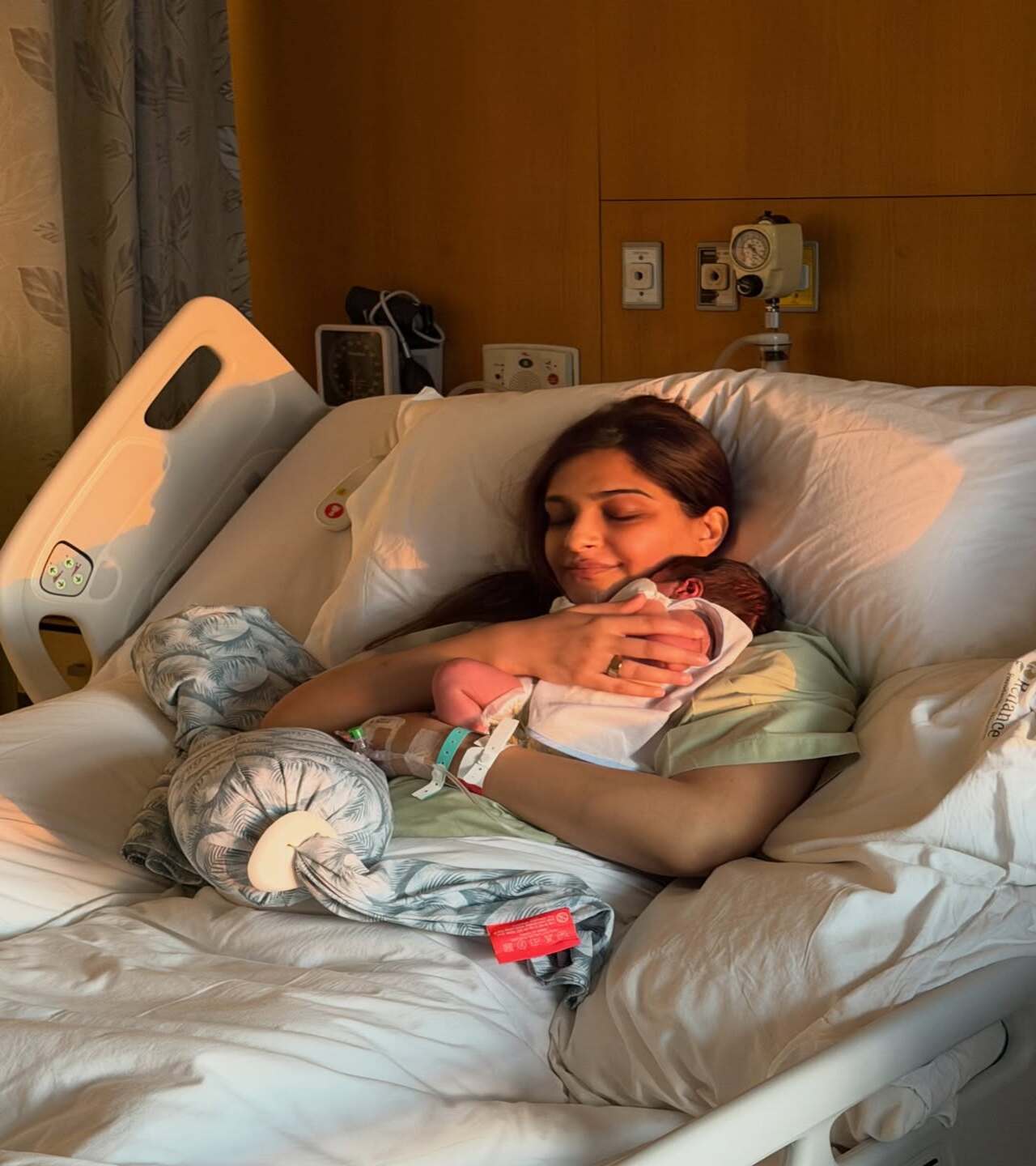 The actress welcomed her second son on 29 March. In this glimpse, Sonam is seen lying on a hospital bed, gently cradling her newborn, with her eyes closed and a faint smile of fulfilment on her face